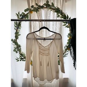 Off-white, long sleeve top.